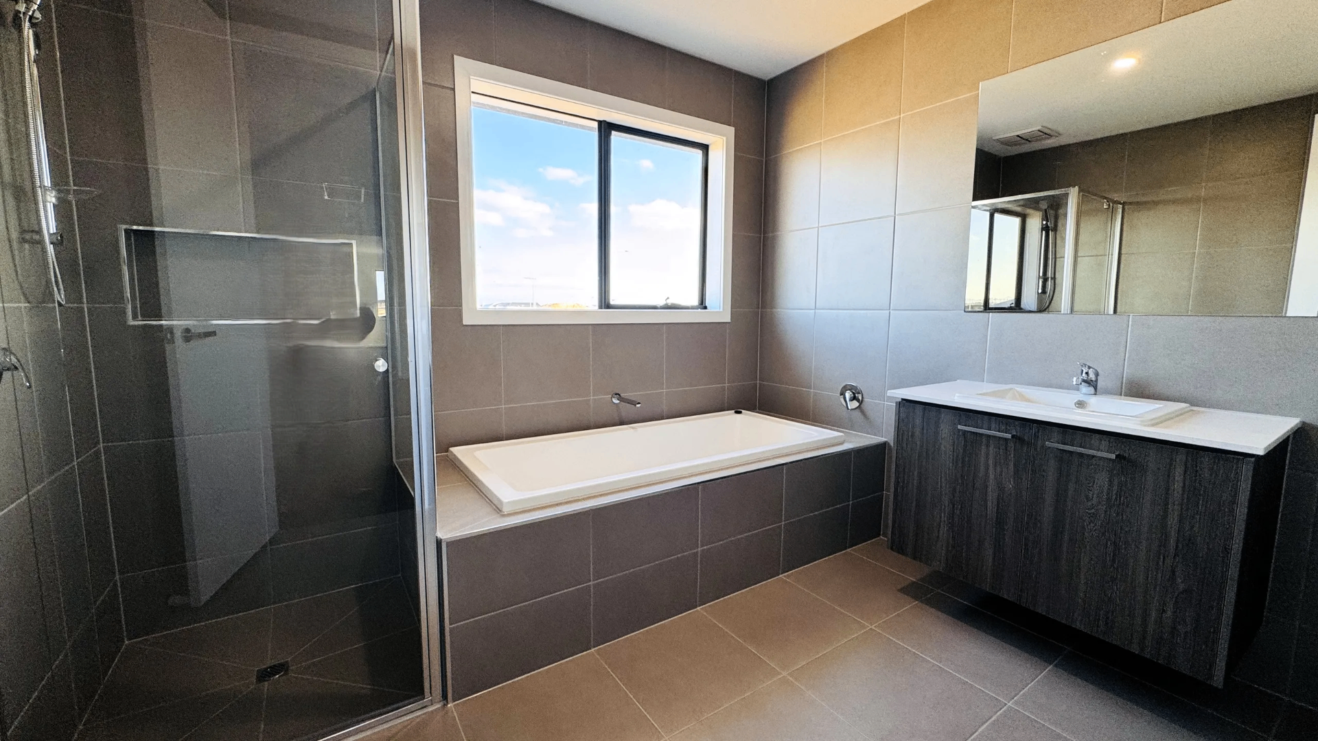 Main bathroom — deep-set tub and walk-in shower