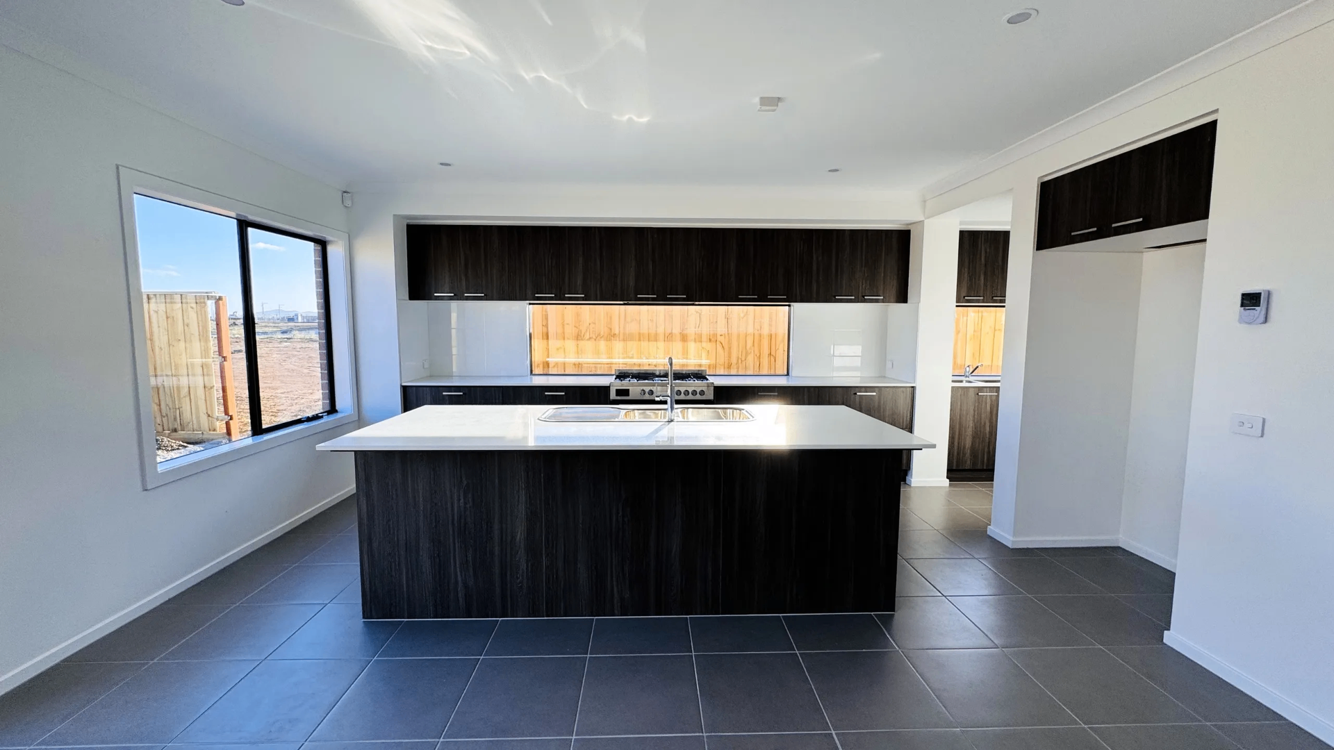 Kitchen island in stone and dark timber